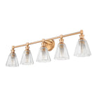 A five-light bathroom vanity light fixture with a brushed brass/gold metal bar and five ribbed clear glass shades, shown against a plain white background.