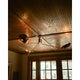 Avondale multi-arm ceiling light with dark bronze finish installed on rustic wooden plank ceiling with windows below