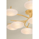 Multi-arm chandelier with oval white glass globes on gold brass arms, styled room close-up