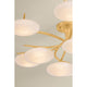 Multi-arm chandelier with oval white glass globes on gold brass arms, styled room close-up