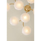Overhead view of Bayberry chandelier with round illuminated white glass globes on gold brass arms