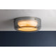 Gunmetal grey round flush mount ceiling light illuminated, showing warm amber glow through diffuser
