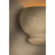 Close-up detail of cream ceramic bubble wall sconce showing textured surface with warm amber glow