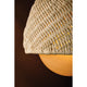 Close-up detail of Piasu wall sconce woven rattan shade showing intricate woven texture with warm amber glow from within