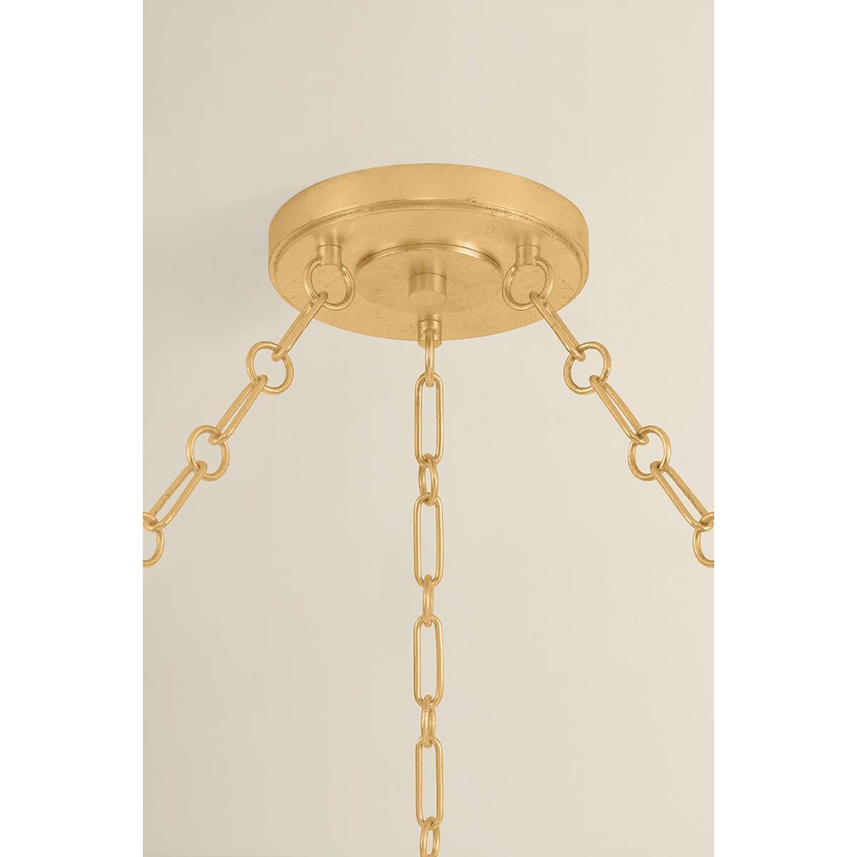 Close-up detail of Tappan chandelier showing antique gold brass canopy and chain link hardware