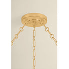 Close-up detail of Tappan chandelier showing antique gold brass canopy and chain link hardware