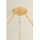 Close-up detail of Tappan chandelier showing antique gold brass canopy and chain link hardware