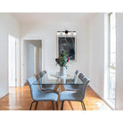 4-light vanity bar light in matte black finish installed on white wall in dining room, lifestyle photo