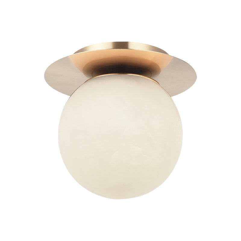 Flush mount ceiling light with champagne gold disc canopy and large frosted globe shade, product photo