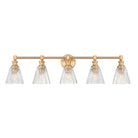 A five-light bathroom vanity light fixture with a warm brass horizontal bar and five clear ribbed glass shades, shown against a plain white background.
