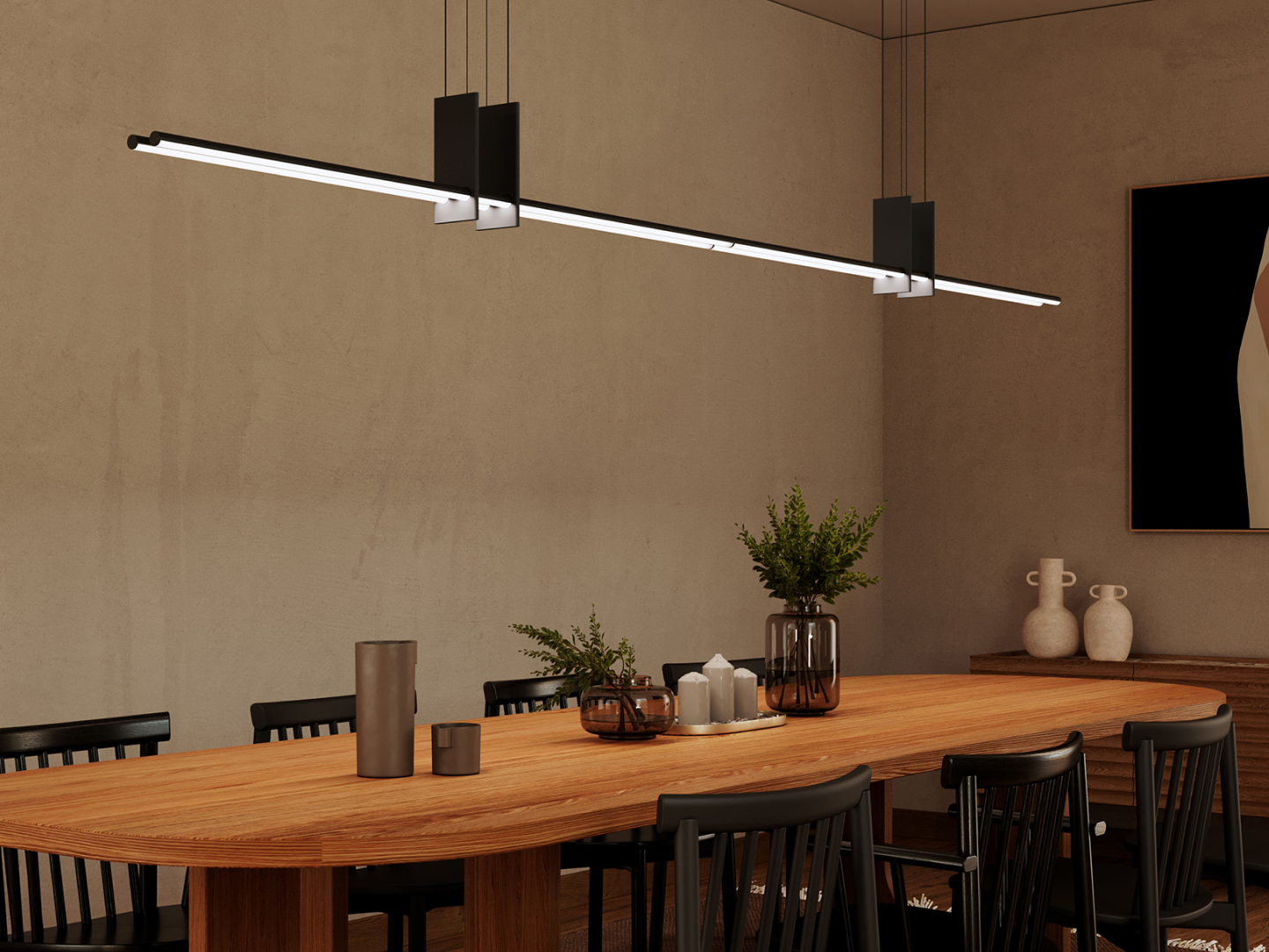 Angled matte black LED tube linear suspension pendant with chrome saddle mounts over oval oak dining table in warm minimalist dining room