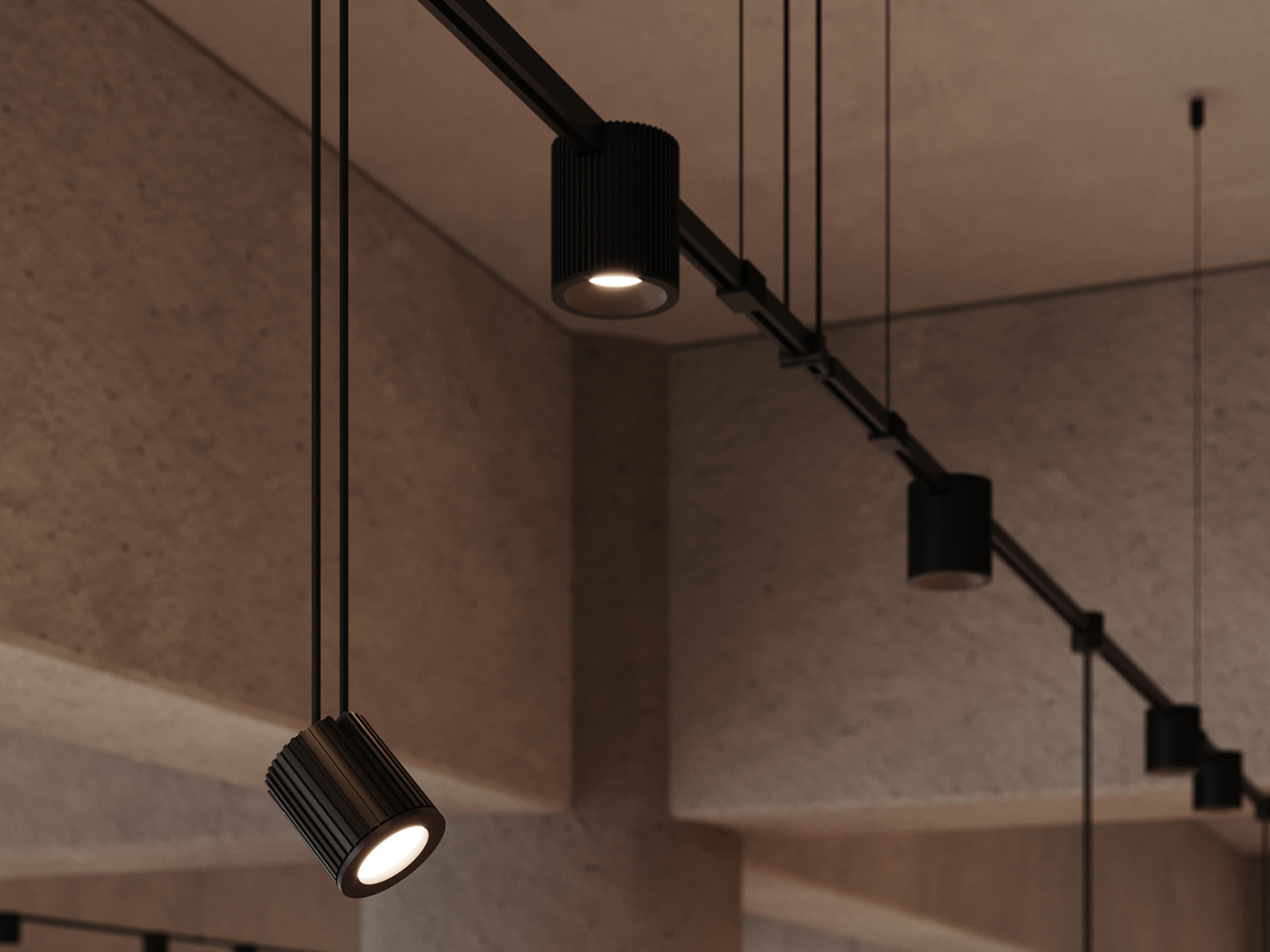 Matte black ribbed cylinder pendant spotlights suspended from ceiling track rail in warm textured concrete interior