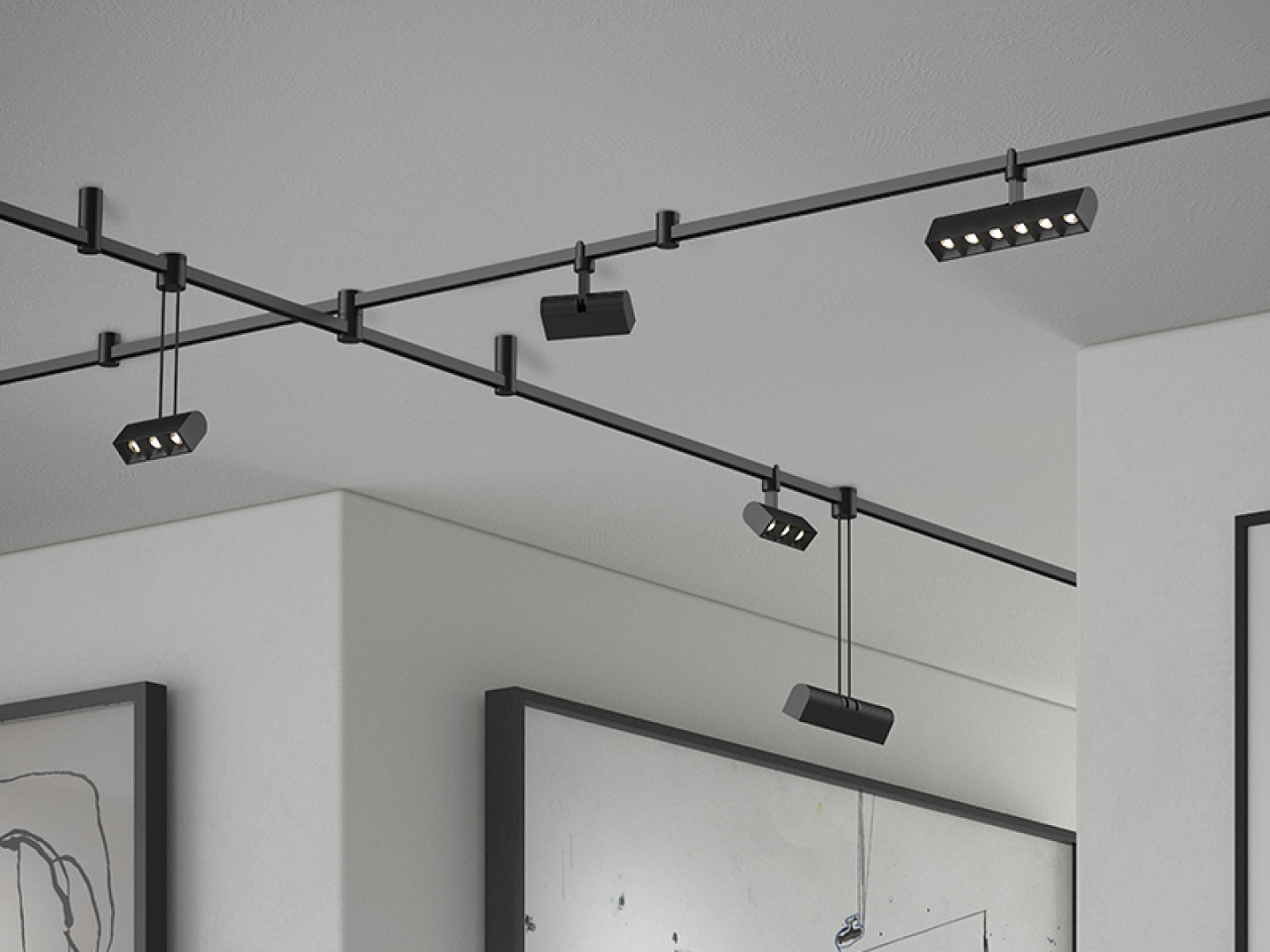 Matte black modular track lighting system with adjustable multi-head LED bar spotlights on cross-rail ceiling mount above framed wall art
