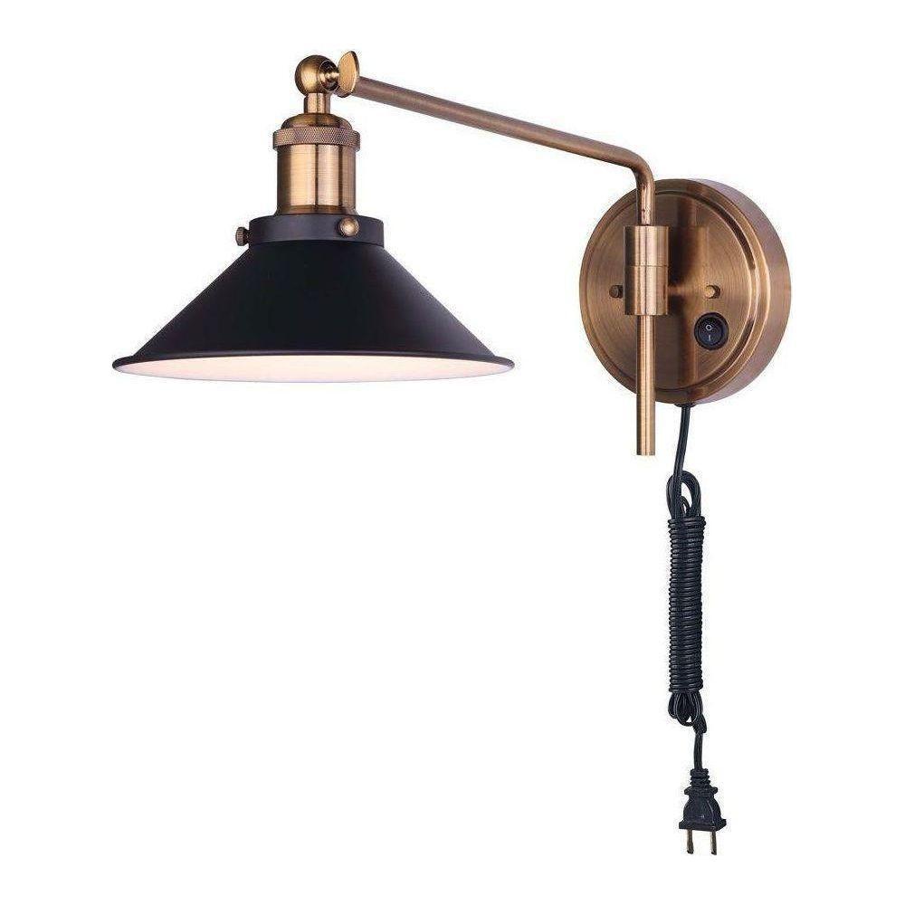 Tally swing arm wall lamp with adjustable antique brass arm, black metal shade, and plug-in cord.